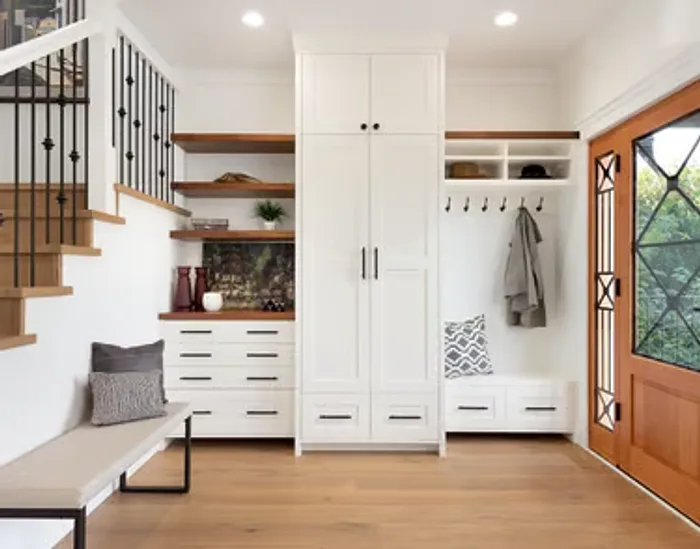 Custom built-in mudroom storage with cabinetry, bench and hooks by Makiry Group in Sarasota, FL