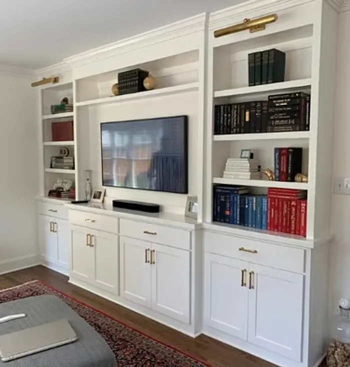 Decorative built-in wall woodwork with display shelving and cabinetry by Makiry Group in Sarasota, FL
